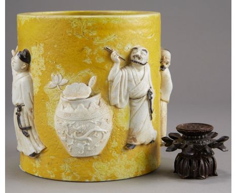 Chinese Republic Period porcelain brush pot and wooden stand. Brush pot is yellow glazed with incised designs and applied fig