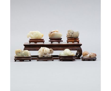 Group of seven Chinese jade carvings of animals. All Qing or earlier. Each comes with an individual wooden stand. Please Note