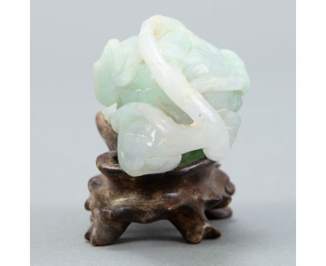 A lovely Chinese pale white and green jade carving of a melon on an early stand.  Provenance: Collection of Augustus Leach Se