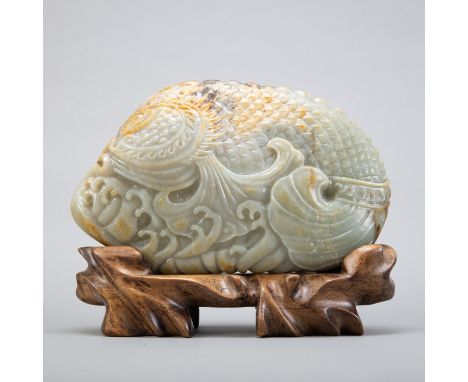 Chinese jade carving of a fish, from a lovely green jade boulder with russet skin which has been well integrated into the dec