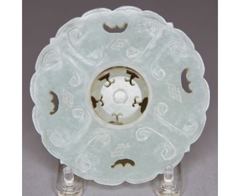 A stunning Chinese jade prayer wheel carved with a stylized silkworm pattern and pierced bats. The central wheel carved to al
