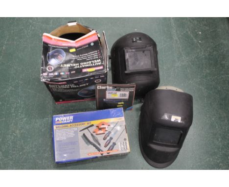 Three welding helmets, darkened glass lens for Clarke welding mask and a Power Craft welding accessory set, all un-used  