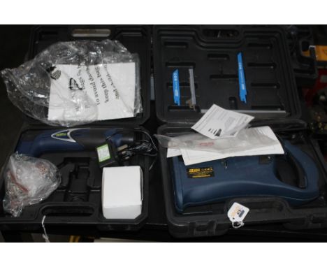 Four cased power tools, multi function saw, multi tool, hot air gun and a grinder 