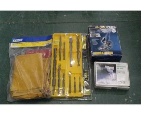 A Reversible air drill, angle grinder stand, welding apron and gauntlets and a Work Zone 10 piece drill and chisel set, un-us