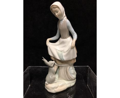 A Lladro porcelain figure, Rabbits Food, No 4826, Vincenze Martinez, issued 1972 retired 1984, 23.5cm high 