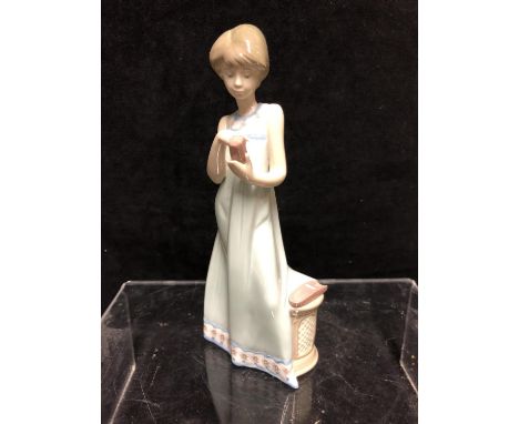 A Lladro porcelain figure, Calling a friend, designed by Vicente Martinez, issued 1989,  retired 1998, 20cm high 