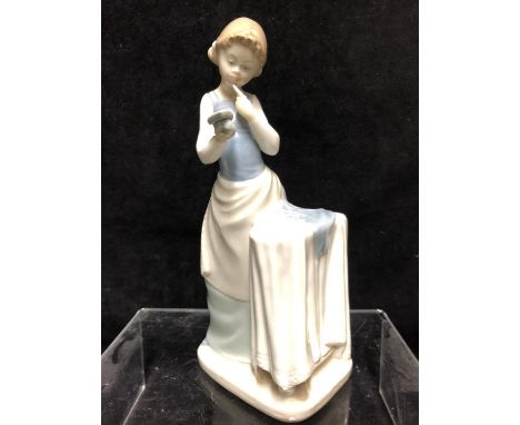 A Lladro porcelain figure, Girl Ironing, No 4981, designed by Jose Roig, issued 1977 retired 1985, 26.5cm high 