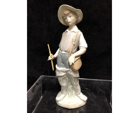 A Lladro porcelain figure, Fisher Boy, No 4809, designed by Salvador Furio, issued 1972, retired 2002, 22cm high 