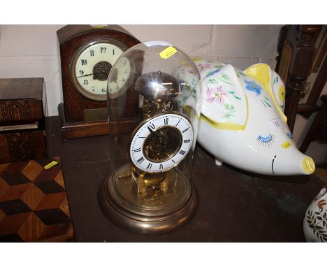 A Junghans anniversary clock contained under glass dome
