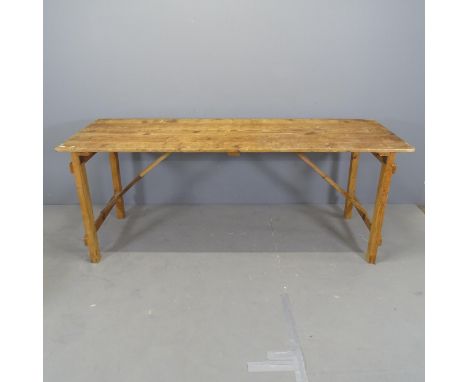 A vintage pine plank-top trestle table on folding base. 191x75x66cm. 
