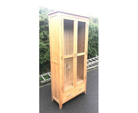 light oak, two door, one draw glazed cabinet, measuring 75" in height, 34" in width and 14" in depth 