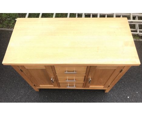 two door, three draw light oak sideboard, measures 31"x38"x18.5" 