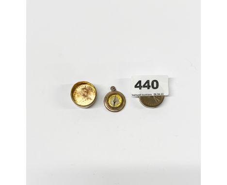 A miniature compass in a small brass and copper box made with two Indian 1918 one quarter Anna coins.