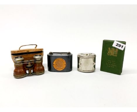 A pair of leather cased opera glasses, two vintage money boxes and a further item.