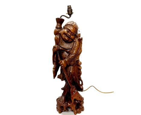 A large Chinese carved hardwood figure of a sage with Chan the three legged toad, mounted as a table lamp, H. 73cm.