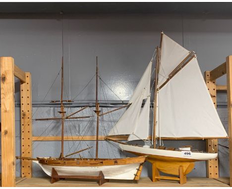 A vintage wooden model of a yacht, 51 x 64cm, together with a further wooden model of a two masted sailing boat.