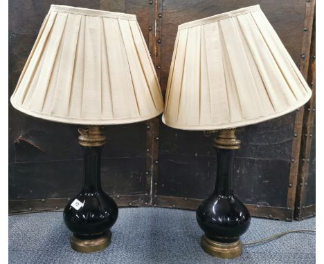 A pair of French antique style ceramic and brass table lamps and shades, H. 56cm. Top fitting unstable on one lamp.