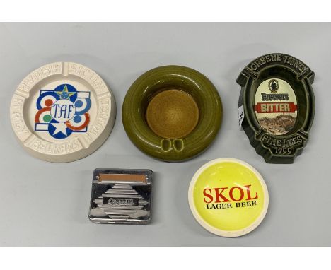 Four ceramic ashtrays and a vintage Rizzla cigarette roller.