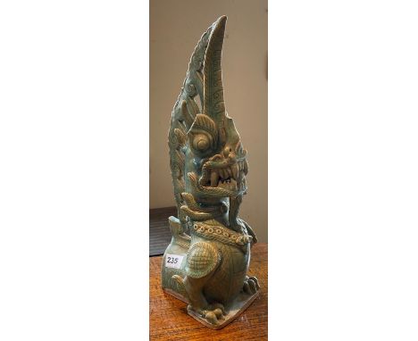 An Oriental celadon glazed ceramic dragon roof tile (A/F).