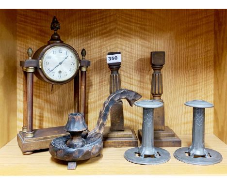 A pair of Art Nouveau pewter candle sticks with a pair of wooden candle sticks, a wooden chamberstick and a mantel clock, H. 