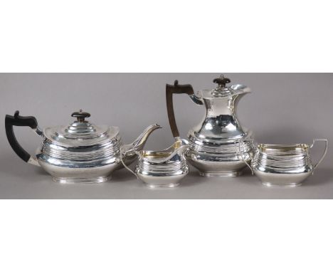 A George V silver four-piece tea service in the regency style, of compressed oblong form with reeded bands; Sheffield 1923-24