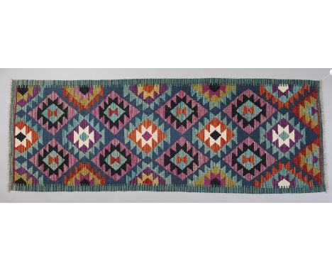 A Maimana Kilim runner with all-over repeating multi-coloured geometric design, 190cm x 66cm.
