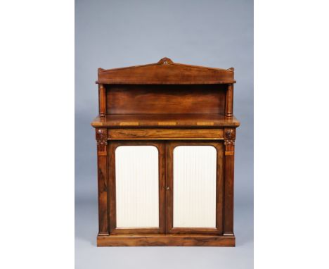A William IV rosewood chiffonier with open shelf to the stage back, fitted with a single long drawer above two shelves enclos