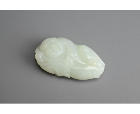 A CHINESE PALE CELADON JADE FIGURE OF A BOY HOLDING A LINGZHI SPRAY. The pendant with pierced hole at the top. 6.3cm length. 