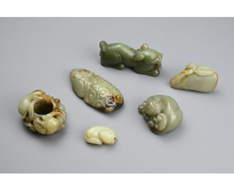 SIX CHINESE CELADON JADE CARVINGS. Comprising: a model of a lion dog, a stylised goose, a small pale jade carving of a sleepi