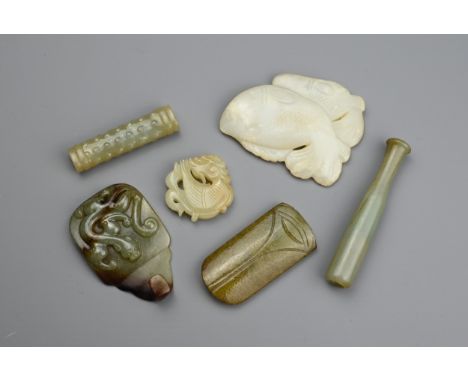 SIX CHINESE CARVED JADE ITEMS. Comprising: a mottled jade pendant carved with a mythical beast, a pale jade carving of two fi