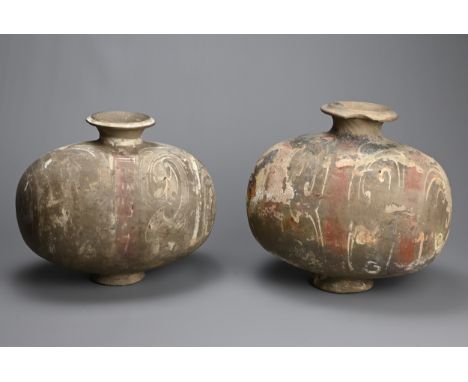 TWO CHINESE PAINTED GREY POTTERY COCOON JARS, WESTERN HAN DYNASTY, LATE 3RD/2ND CENTURY BC, Each with oblong body and flared 