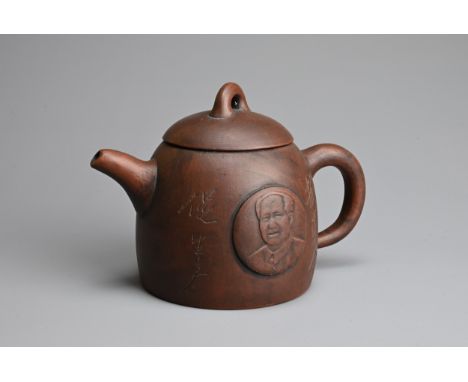 A CHINESE YIXING ZISHA TEAPOT. Featuring portrait of Mao Zedong in relief with inscription. With impressed makers mark to bas