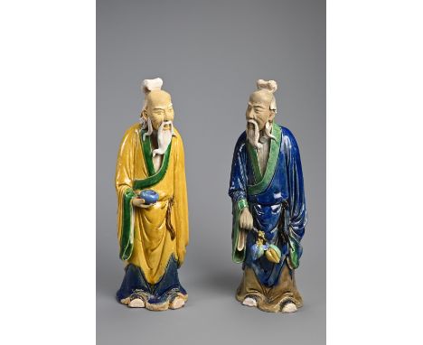 A LARGE PAIR OF CHINESE SHIWAN POTTERY FIGURES, EARLY 20TH CENTURY. Sancai glazed standing figures dressed in robes holding a