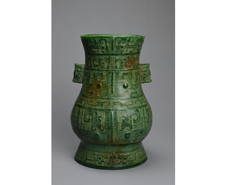 A DECORATIVE CARVED ARCHAISTIC JADE VASE, LATE 20TH CENTURY. Modelled after a Chinese archaic bronze vessel, decorated in rel