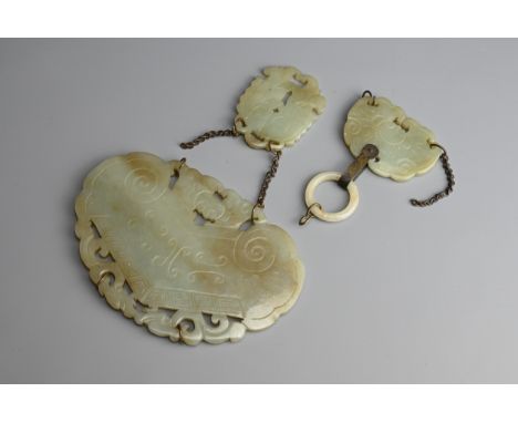 CHINESE CARVED CELADON JADE PENDANT SECTIONS, QING DYNASTY. A larger carved pendant in the form of a Huang chime of ruyi form