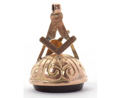 A Masonic fob, the round fob with Masonic red glass intaglio set in gold mount with Masonic symbols and stamped 9ct, 32mm lon