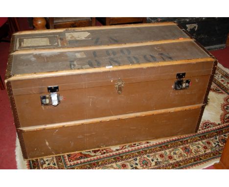 An early 20th century canvas clad wooden and leather studded cabin trunk, having end carry handles and stencilled 'London 100
