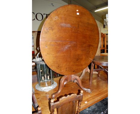 A George III mahogany circular tilt-top pedestal tripod table, having birdcage action and raised on hipped supports, dia. 94c