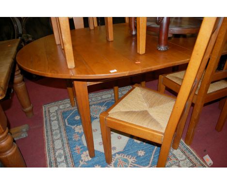 A contemporary French light oak dining suite, comprising D-end extending dining table with pull-out action and two extra drop