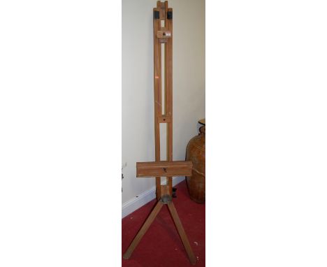 A beech freestanding artists easel with black painted metal mounts