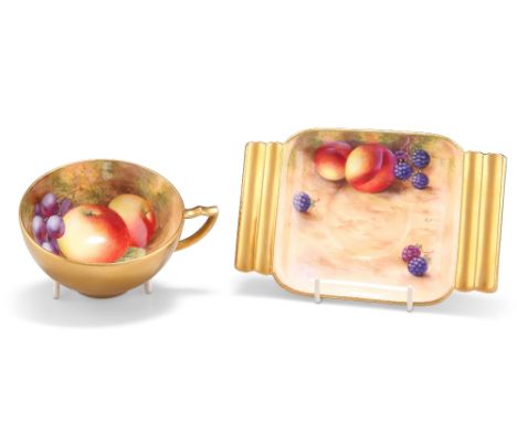 A ROYAL WORCESTER FRUIT PAINTED CUP AND SAUCER, painted by Ayrton, the saucer in Art Deco style with fluted handles, puce pri