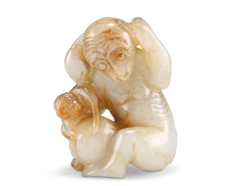 A CHINESE JADE MONKEY AND PEACH GROUP, carved and pierced depicting a monkey and young, playing with peaches. 6cm by 4cm by 3