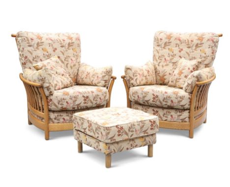 A PAIR OF ERCOL 'RENAISSANCE' LIGHT ELM LOUNGE CHAIRS AND FOOTSTOOL, with floral patterned upholstery and loose cushions. (3)