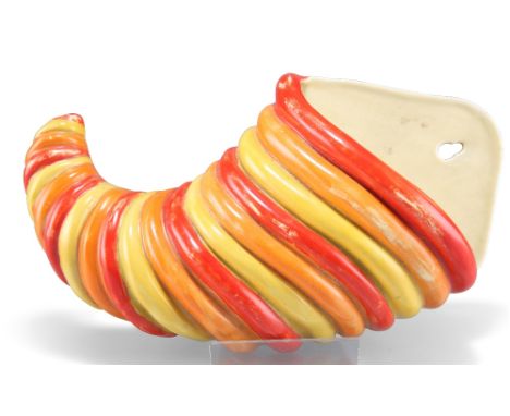 CLARICE CLIFF FOR WILKINSON POTTERY - A CORNUCOPIA WALL POCKET, ribbed form and painted in tones of red, orange and yellow, b