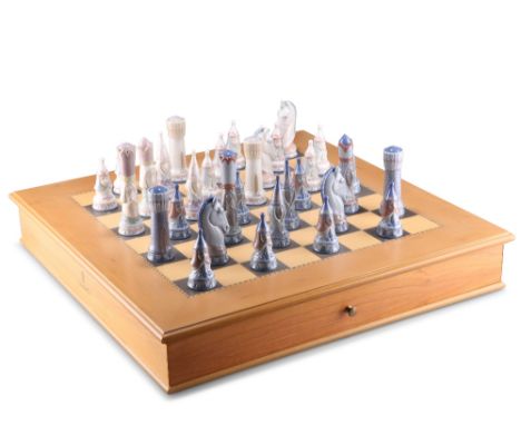 A LLADRO MEDIEVAL CHESS SET, WITH BOARD, thirty two pieces, in tones of white and grey, blue printed marks, dated 1995, the w