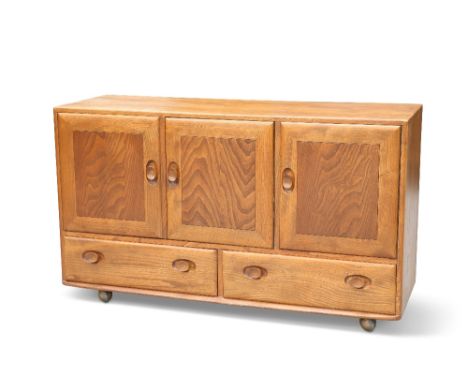 AN ERCOL LIGHT ELM SIDEBOARD, with three cupboard doors above a pair of drawers. 75.5cm high, 129cm wide, 43cm deepCONDITION 