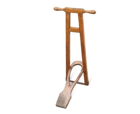 AN EARLY 20TH CENTURY BEECH BOOT JACK, with inset Durham Light Infantry insignia and motto. 82cm highCONDITION REPORTBoot jac