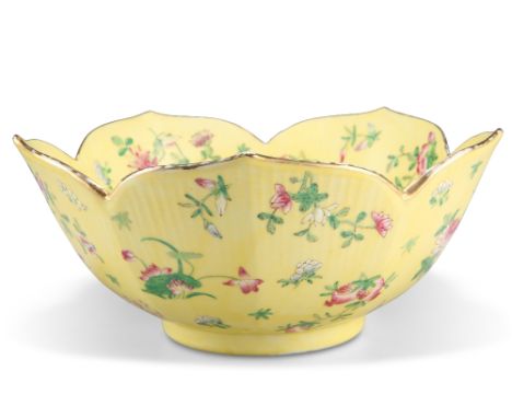 A CHINESE FAMILLE ROSE YELLOW-GROUND BOWL, of lotus-form, enamel painted throughout with foliate sprigs. 25cm diameterCONDITI