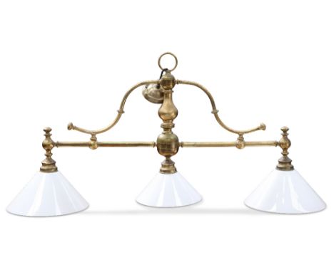 A 20TH CENTURY BRASS BILLIARDS TABLE LIGHT, the brass tubular arm with scroll supports and fitted with three opaque white gla