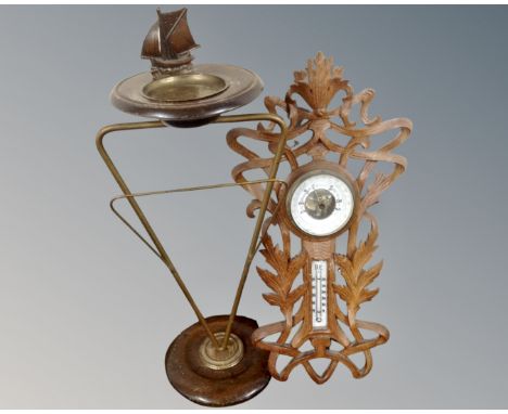 A 20th century brass and beech nautical smoker's stand together with a carved Black Forest style barometer 